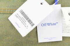 Off-White clothing tags on a textured fabric background