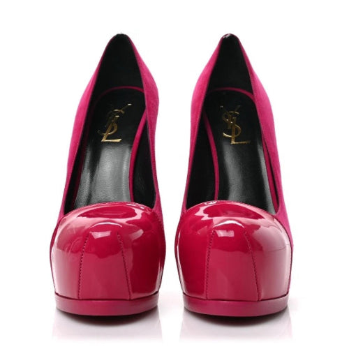 A pair of Yves Saint Laurent high-heeled pumps in glossy patent pink and magenta suede, featuring a black insole with a gold YSL logo, shown against a plain white background.