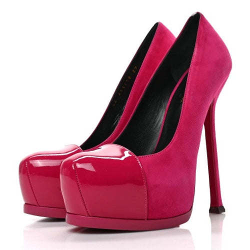 A pair of bright fuchsia pink high-heeled pumps with glossy patent leather uppers and platform soles, shown against a plain white background.
