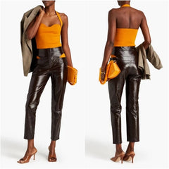 Woman wearing a yellow top and black leather pants, holding a yellow clutch.