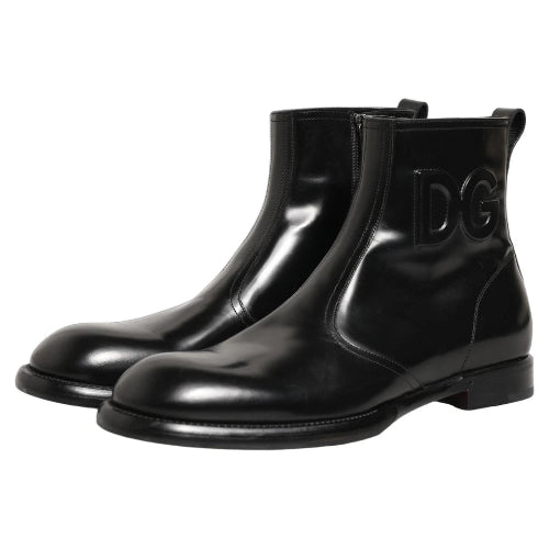 A pair of glossy black ankle boots with decorative side cutouts, shown against a plain white background.