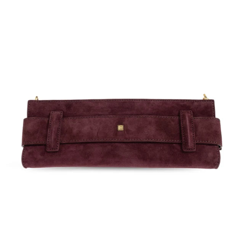 A burgundy suede clutch bag with a wide strap across the front, a small gold square logo plaque, and gold-tone zipper pulls, shown against a plain white background.