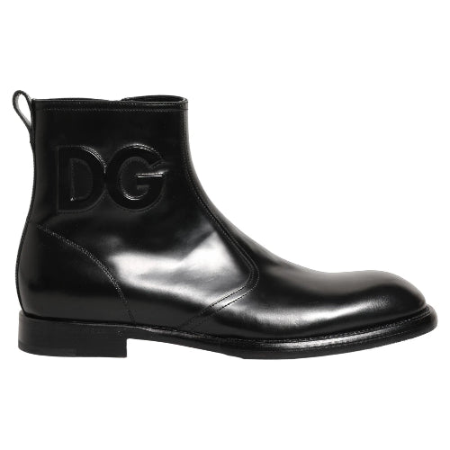 A black leather Chelsea boot with a glossy finish, featuring a low block heel and a prominent interlocking DG logo on the side, set against a plain white background.