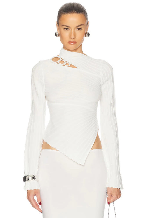 Woman wearing a white long-sleeve top with cut-out design on a white background