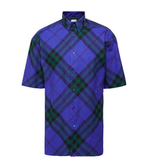 Blue and green plaid shirt on a light gray background