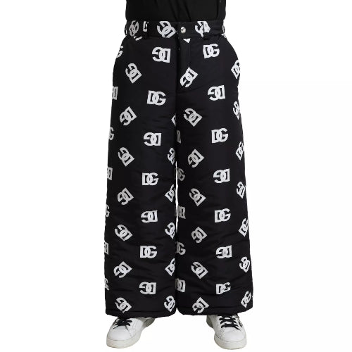 A pair of Dolce & Gabbana black wide-leg pants with white DG logo print, featuring a flat front design and side pockets.