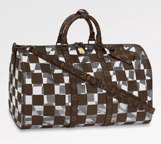 A Louis Vuitton duffle bag with a checkered pattern in brown and white colors, featuring leather material and a bandouliere strap.