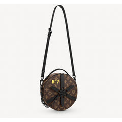 Round brown bag with black strap and 'No. 7' text on a white background