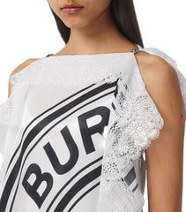 White top with lace details and 'Burberry' logo on a plain background