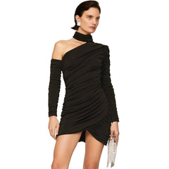 Woman wearing a black one-shoulder dress on a beige background