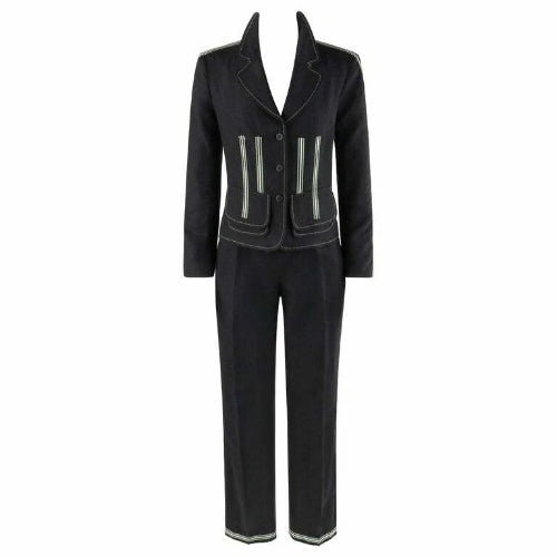 A dark charcoal gray two-piece suit featuring a tailored blazer with light gray contrast piping and zippered pockets, paired with matching straight-leg trousers.