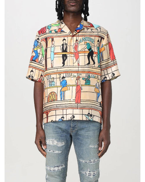 Person wearing a colorful patterned shirt and jeans on a white background