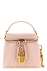 A light pink leather top-handle handbag with gold-tone hardware, featuring a front zip closure, a decorative leather tassel with a padlock detail, and a detachable chain strap, shown on a plain white background.