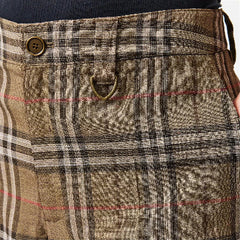 Close-up of a plaid waistband and front pocket area of tailored trousers. The fabric is a textured taupe-brown with black, beige, and thin red overcheck lines, featuring a button closure and a small brass loop detail.
