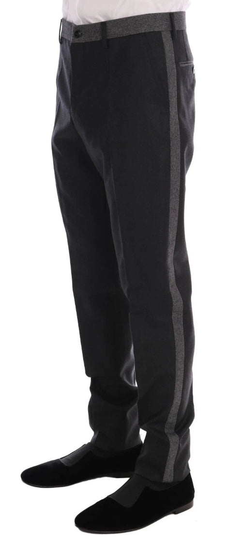 Black pants with gray stripes worn by a person on a white background