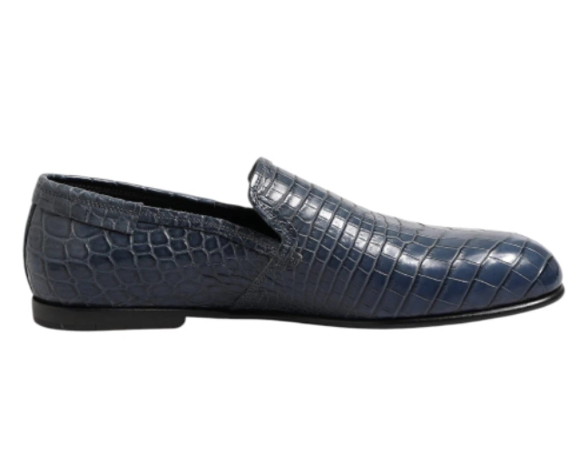 Blue crocodile-textured loafer shoe on a white background