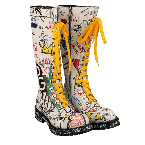 Pair of white rain boots with colorful graffiti-style design and yellow laces on a white background