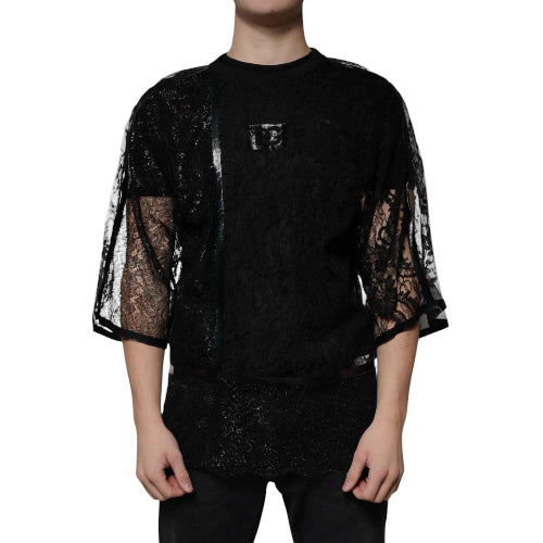 Black lace top worn by a person on a white background