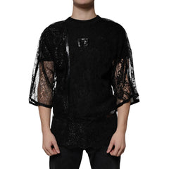 Black lace top worn by a person on a white background