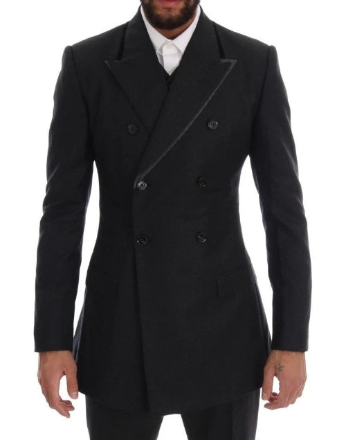 Black double-breasted coat worn by a person on a white background