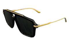 Black sunglasses with gold frames on a textured gray background