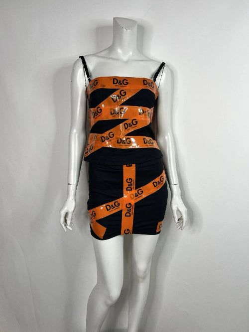 Black and orange dress with 'D&G' logo on a mannequin against a white background
