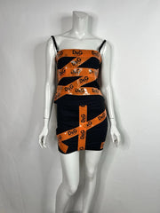 Black and orange dress with 'D&G' logo on a mannequin against a white background
