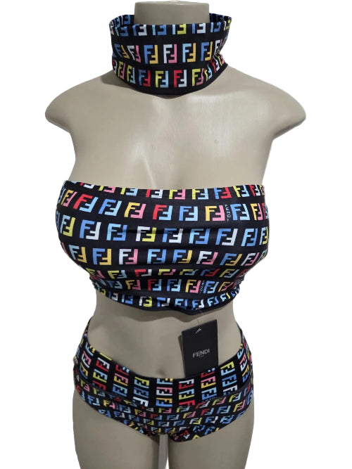 Mannequin wearing a colorful patterned bikini set with a matching neck scarf against a white door background.