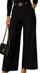 A person wearing black wide-leg cropped trousers with a matching black belt featuring gold-tone double-G hardware, paired with a black top and a black quilted shoulder bag with a gold chain strap.