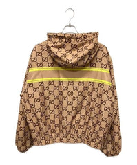 Beige jacket with Gucci logo pattern on a white background