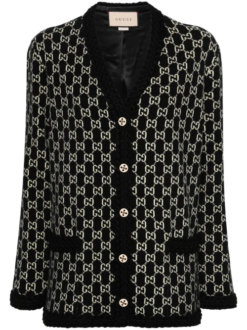 A Gucci black and beige GG monogram tweed cardigan with black fuzzy trim, buttoned front, and a visible Gucci label at the collar.