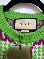 Green Gucci sweater with brand label on a hanger