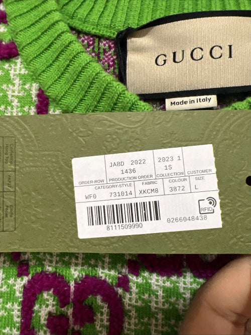 Green Gucci garment with label showing 'Made in Italy' and product details.