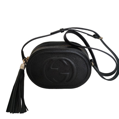 Black leather crossbody bag with tassel on a white background