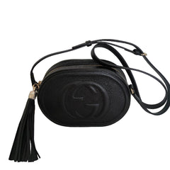 Black leather crossbody bag with tassel on a white background