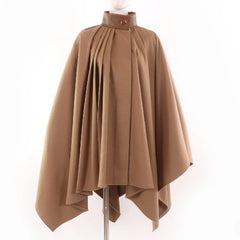Brown cape on a mannequin against a white background