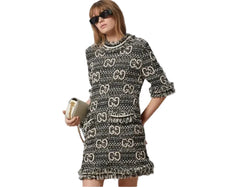 Woman wearing a patterned dress with a plain background