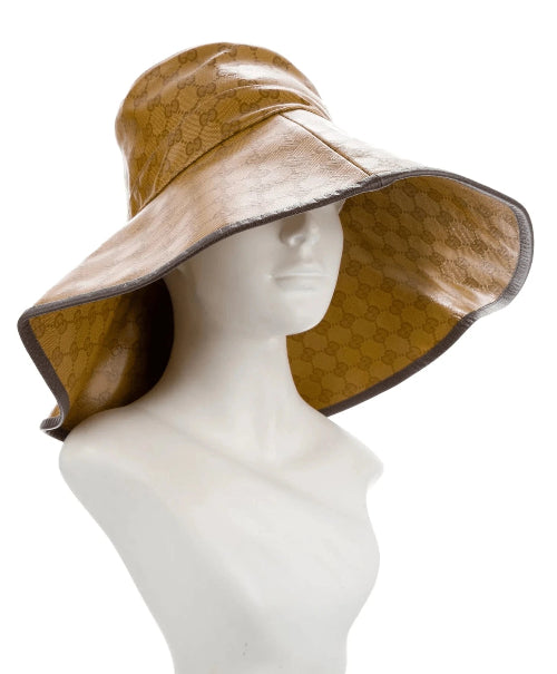 A wide-brimmed sun hat in a warm tan or camel shade, displayed on a white mannequin head against a plain white background.