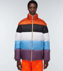 Person wearing a colorful quilted jacket with a white background