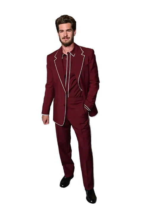 Man in a burgundy suit with white trim standing in an outdoor setting with columns.