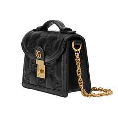 Black embossed handbag with gold chain and lock on a white background
