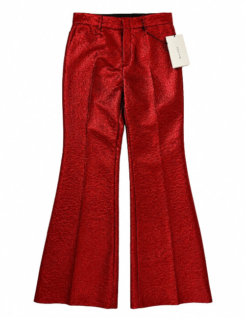 Red textured wide-leg trousers with a metallic sheen, shown flat against a white background with a white brand tag attached.