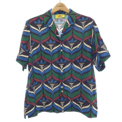 Colorful patterned shirt on a hanger with Adidas logo in the background