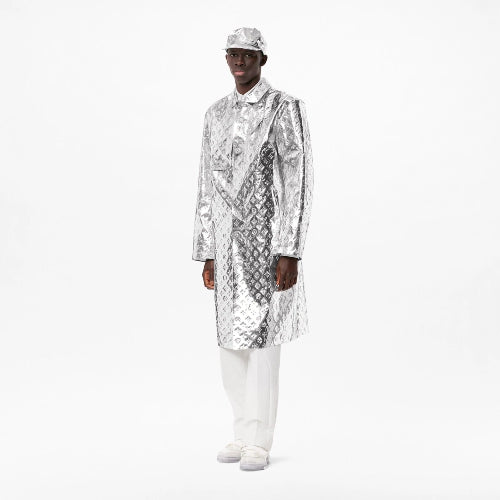 Person wearing a shiny silver and black patterned coat on a white background