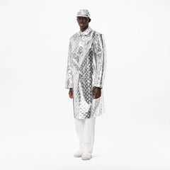 Person wearing a shiny silver and black patterned coat on a white background