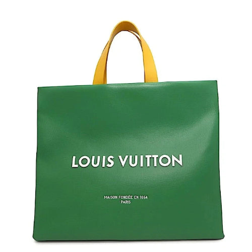 Green Louis Vuitton bag with yellow handles on a white background