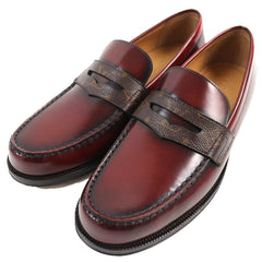 Pair of brown leather loafers on a white background