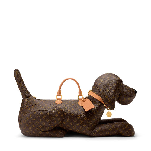 A Louis Vuitton monogram dog-shaped shoulder bag in brown canvas with tan leather handles and collar, shown on a plain white background.