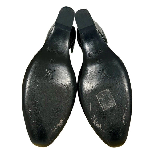 A pair of black leather shoe lasts or wooden shoe trees with a glossy finish, showing the embossed Louis Vuitton 'LV' logo and size markings on the bottom sole, set against a plain white background.