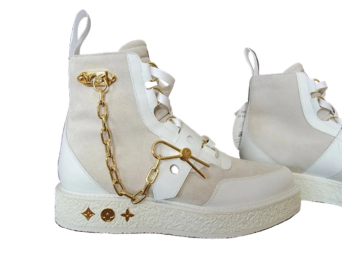 High-top sneakers with gold chain details on a white background